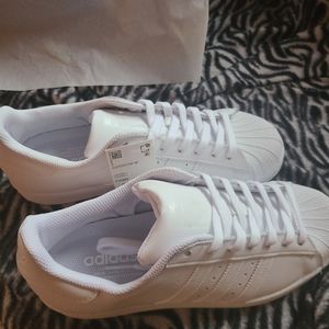 White Adidas Superstar sneakers, size 9. Almost new, only worn a few times.